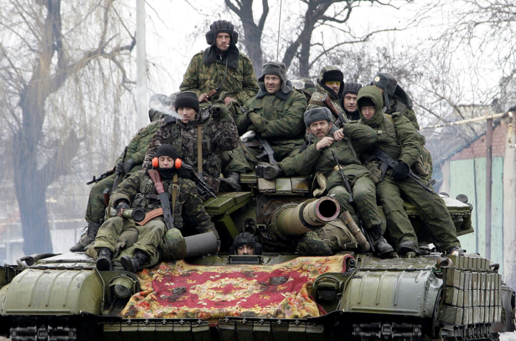 Members of the armed forces of the separatist self-proclaimed Donetsk People's Republic drive a tank on the outskirts of Donetsk