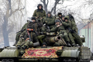 Members of the armed forces of the separatist self-proclaimed Donetsk People's Republic drive a tank on the outskirts of Donetsk