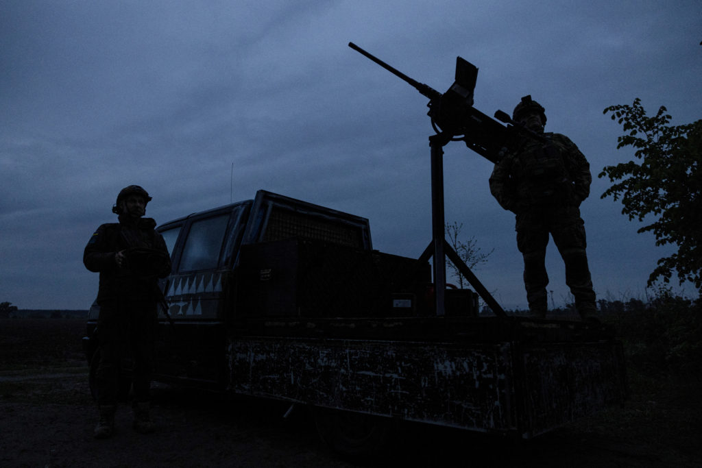 FILE PHOTO: Members of a mobile air defence volunteer unit stand next to their machine gun during the most massive Russian drone attack in Kyiv region